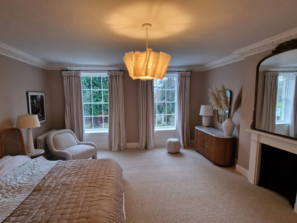 Neutral painted bedroom with fireplace in Cheltenham