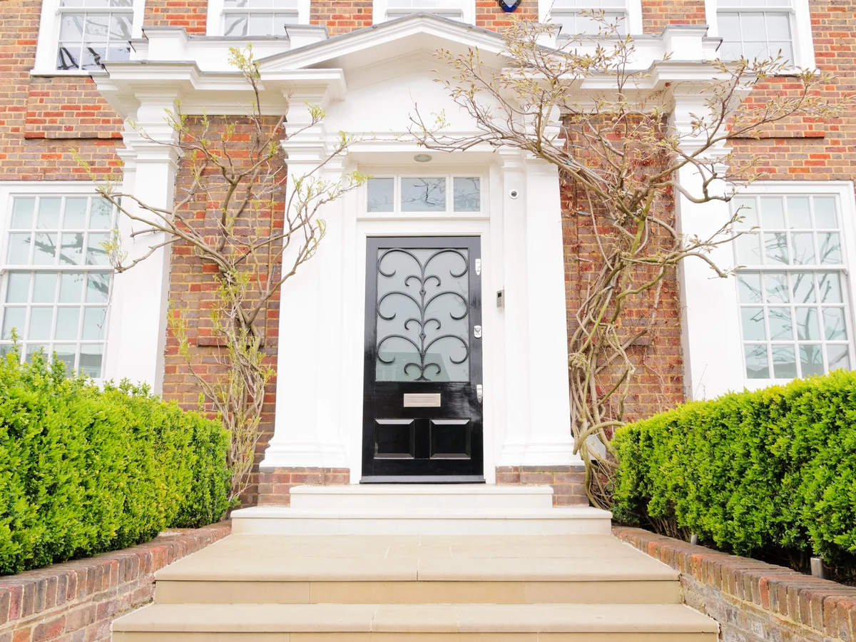 Exterior painting on a large red brick house in Tivoli by Cheltenham Decorators