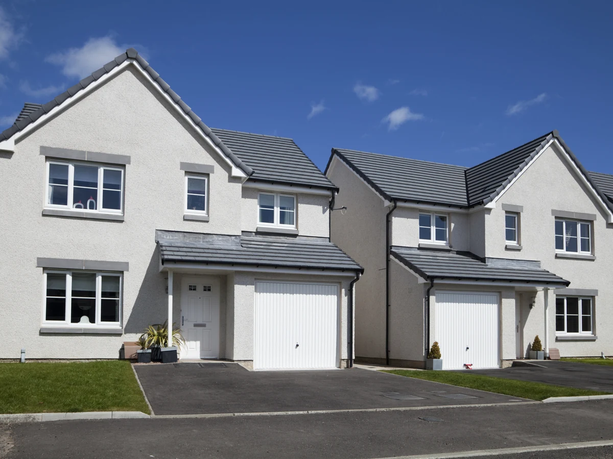 Two white rendered homes with freshly painted exterior by Cheltenham Decorators