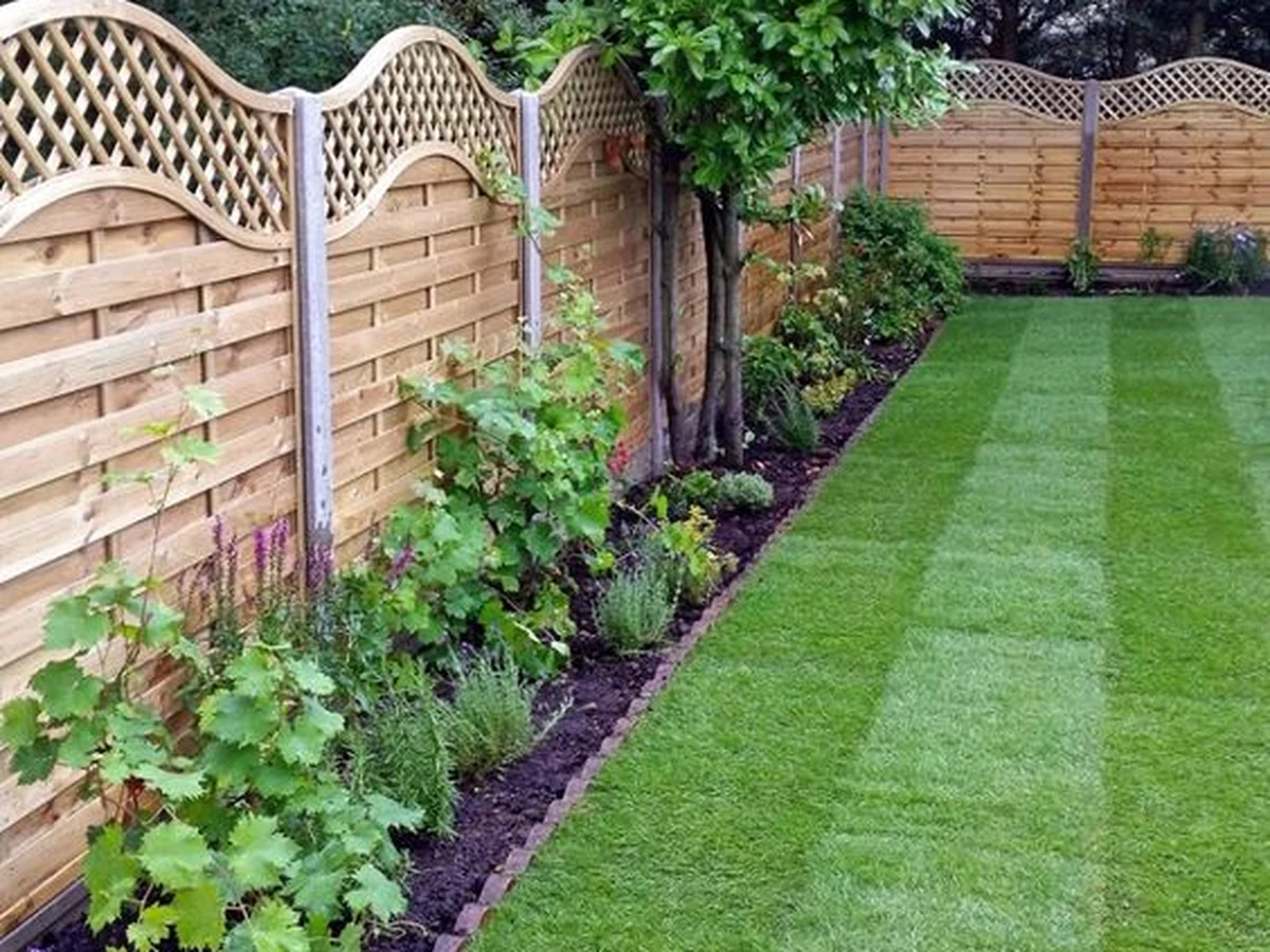 Decorative wooden garden fence freshly stained in Cheltenham