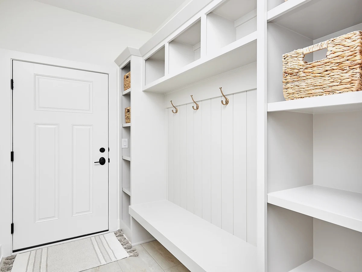 Freshly painted white mudroom hallway with coat storage in a Warden Hill home by Cheltenham Decorators