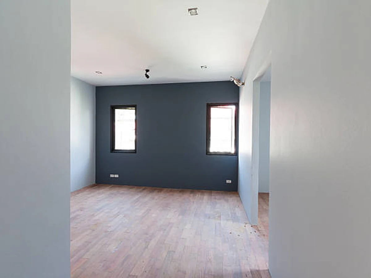 Dark painted empty room interior in Cheltenham, bold colour wall treatment