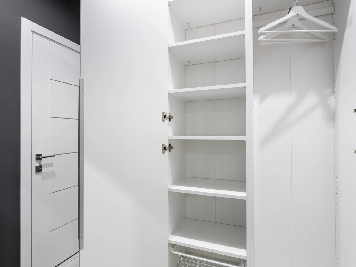 Interior painting of a white bedroom with wardrobe in Up Hatherley by Cheltenham Decorators