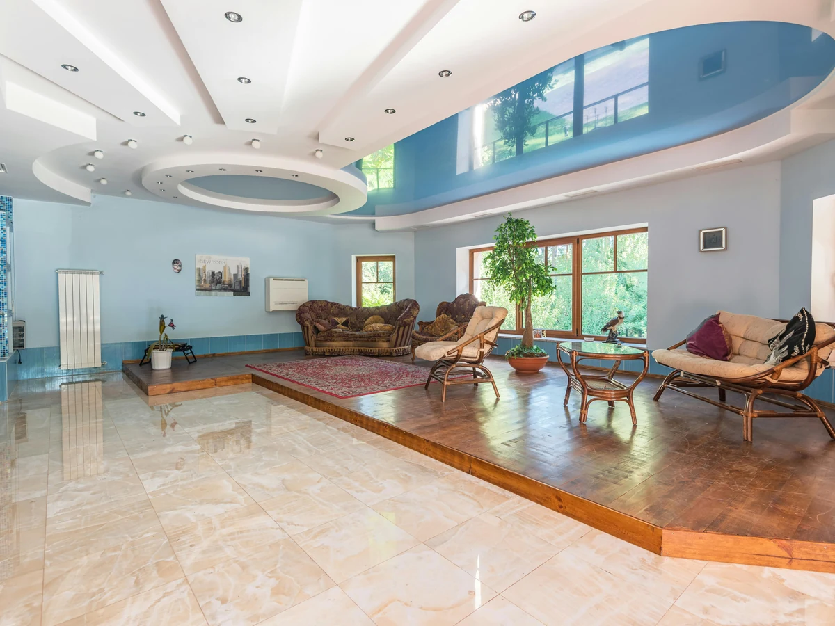 Large open living room painted in blue by Cheltenham Decorators
