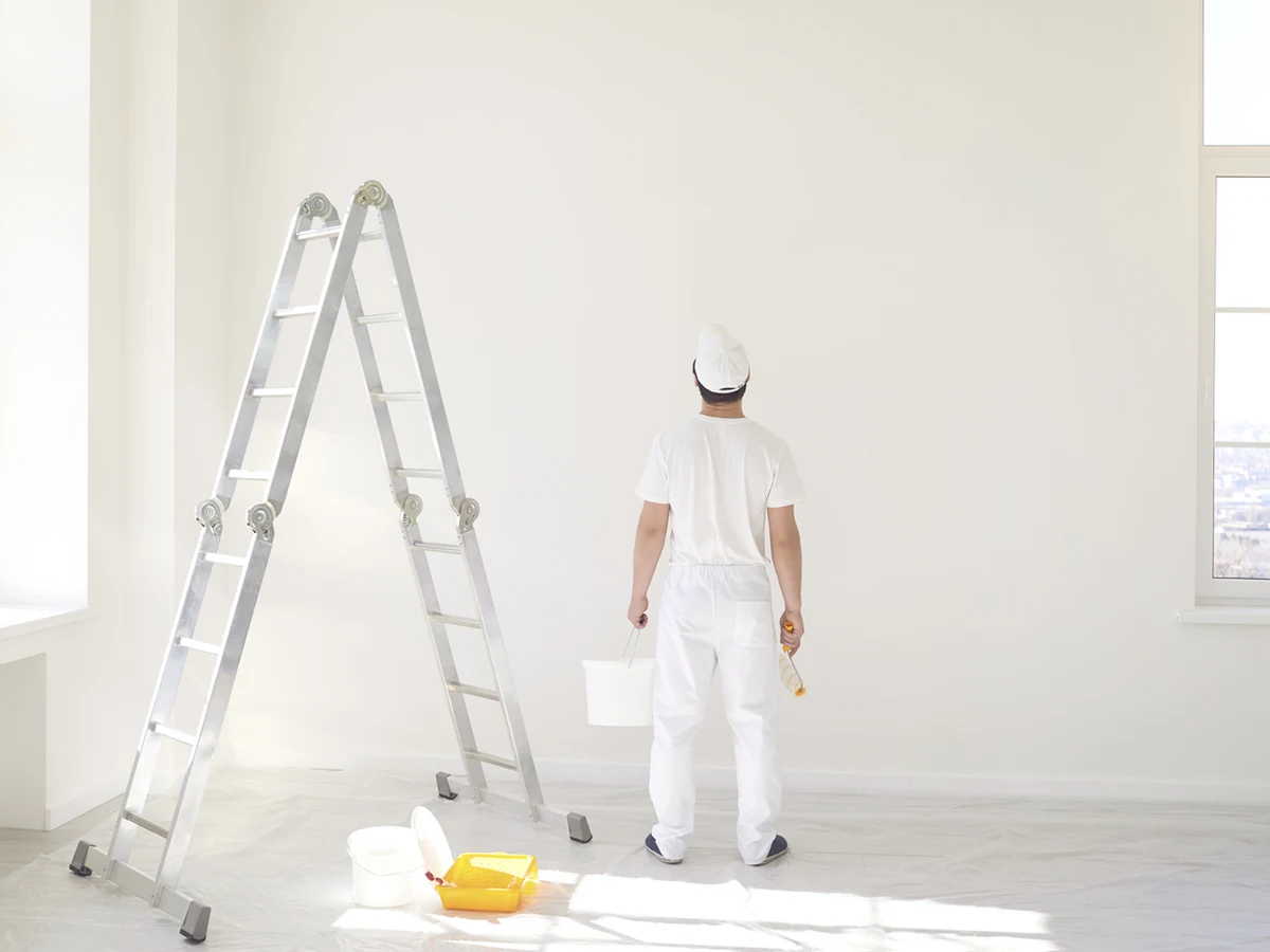 Cheltenham Decorators painter on a white ladder decorating a Warden Hill property